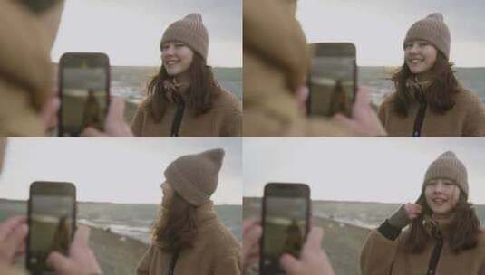 男人用手机给女朋友拍照高清在线视频素材下载