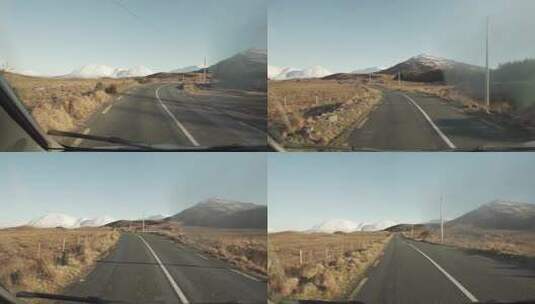孤独的汽车行驶在爱尔兰的山区高清在线视频素材下载