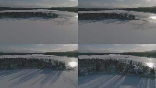 航拍阳光下的湖泊和雪域林地高清在线视频素材下载