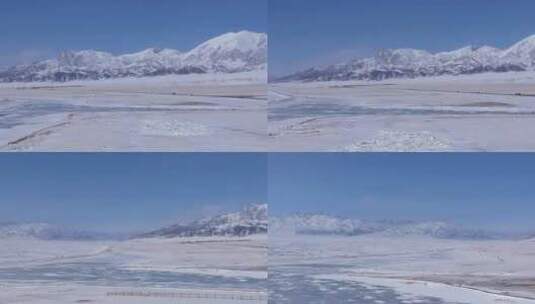 航拍新疆冬季赛里木湖冰封湖面雪山冰湖雪景高清在线视频素材下载