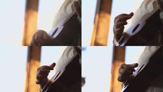 手部特写弹奏尤克里里的画面高清在线视频素材下载