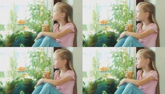 女孩坐在窗台上喝果汁高清在线视频素材下载