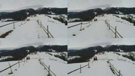雪山中用栅栏围起来的小路高清在线视频素材下载