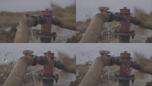 沙漠中的浇水管道 水龙头洒水喷水 水流特写高清在线视频素材下载