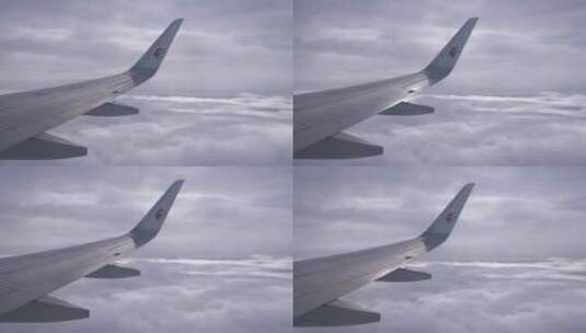 飞机飞过天空机翼天空阴天乌云东方航空高清在线视频素材下载