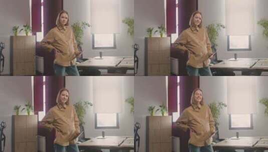 孕妇在办公室拿着平板电脑在镜头前摆姿势高清在线视频素材下载