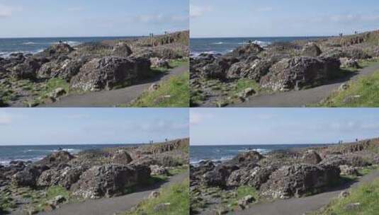 海边上巨石上的游客高清在线视频素材下载