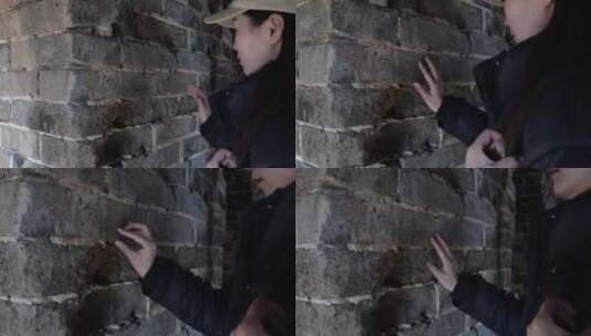 中国女性站在烽火台里观察墙壁文字高清在线视频素材下载