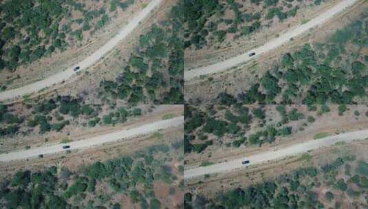 空中跟踪拍摄的吉普车行驶在非洲偏远荒地的土路上高清在线视频素材下载