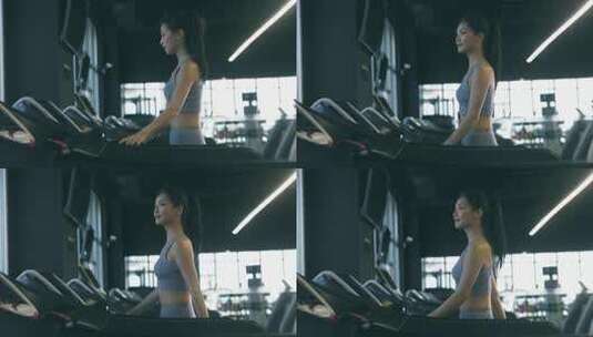 穿运动内衣的年轻女性在健身房使用跑步机高清在线视频素材下载