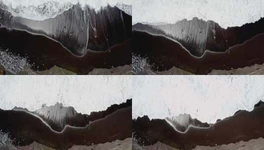 泡沫海浪冲刷着亚速尔群岛的黑色沙滩，俯瞰。高清在线视频素材下载