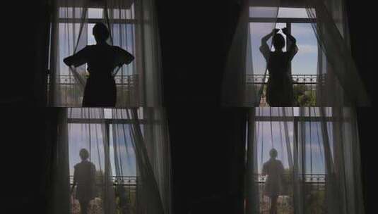 一个女人打开阳台的窗户，享受婚礼前的早晨高清在线视频素材下载