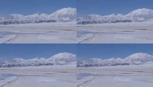 航拍新疆冬季赛里木湖冰封湖面雪山冰湖雪景高清在线视频素材下载