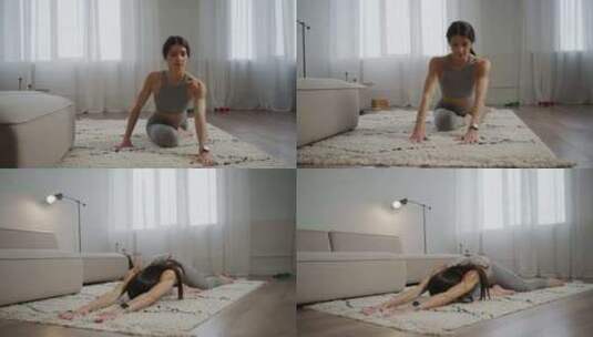 漂亮的女运动员在家地板上伸展瑜伽和健身训高清在线视频素材下载