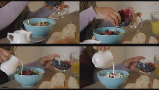 把浆果和酸奶放进格兰诺拉麦片的女人的特写高清在线视频素材下载