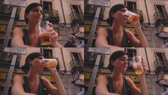 4k慢动作。美丽的高加索女人在马德里（西班牙）的一家酒吧喝啤酒。西班牙女孩西蒂高清在线视频素材下载