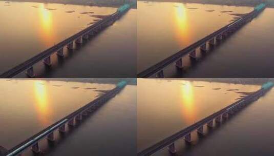 黄昏日落高铁驶过城市跨江大桥高清在线视频素材下载
