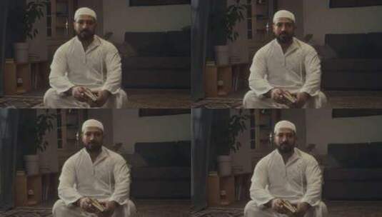 大胡子穆斯林男子在家拿着古兰经摆姿势的肖高清在线视频素材下载