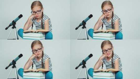 女孩在望远镜旁看书高清在线视频素材下载