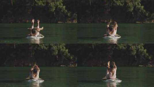湖中桨板上练瑜伽的女人高清在线视频素材下载