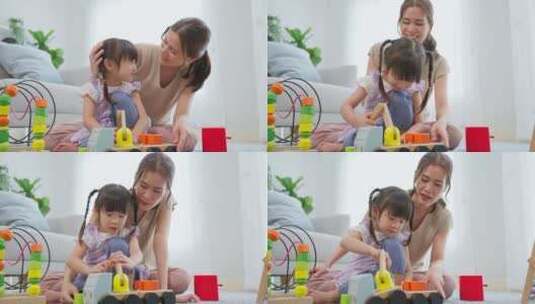 亚洲美丽的爱妈妈和女儿在家里玩教育游戏。高清在线视频素材下载