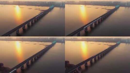 黄昏日落下的高铁穿过城市跨江大桥高清在线视频素材下载