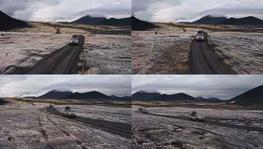 两辆吉普车在火山地面上空行驶高清在线视频素材下载