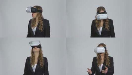 女人在灰色背景上戴着虚拟现实眼镜高清在线视频素材下载