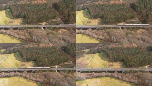 火车在高架轨道上穿越乡村景观的鸟瞰图。多莉左高清在线视频素材下载