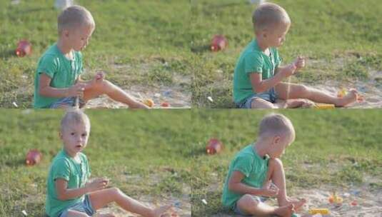 男孩在户外玩沙子玩具高清在线视频素材下载
