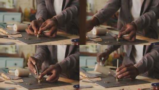 非裔美国工匠的手在皮革车间使用工具制作腰带高清在线视频素材下载