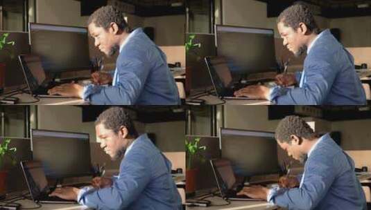 黑人在办公室用两台电脑写代码高清在线视频素材下载