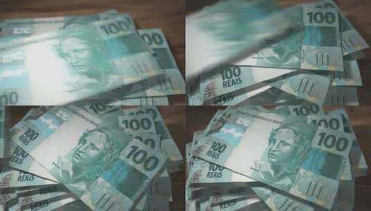 巴西雷亚尔100元钞票落在桌子上高清在线视频素材下载