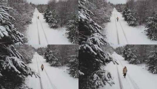 一个快乐的女人在雪地小径上自由奔跑高清在线视频素材下载