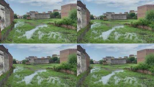 被洪水淹没的田野，背景是建筑物高清在线视频素材下载