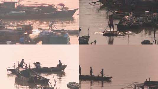 波光粼粼夕阳下渔民撑船于渔船间高清在线视频素材下载