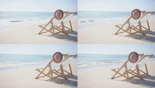 海滩上的躺椅和帽子描绘了一个宁静、阳光明高清在线视频素材下载