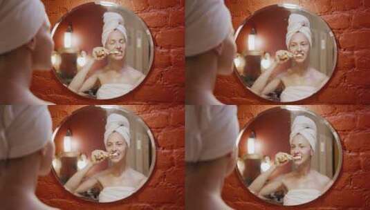 一个在镜子前刷牙的女人高清在线视频素材下载