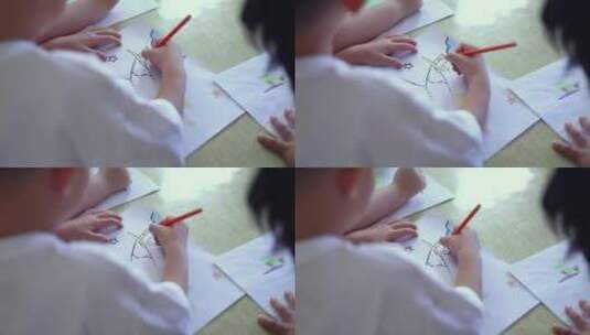 小孩绘画过肩特写拍摄高清在线视频素材下载