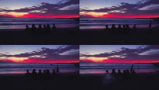 黄昏时分孩子们坐在海滩边的剪影高清在线视频素材下载