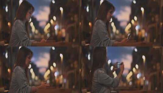 女士使用手机拍摄城市夜景高清在线视频素材下载
