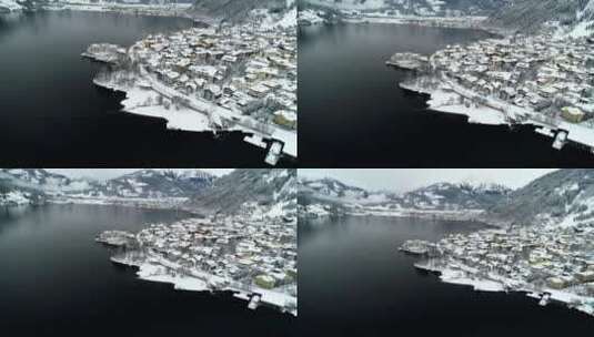 白雪皑皑的小镇和湖泊的景色高清在线视频素材下载