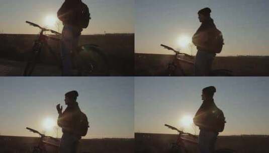 日落时分骑自行车的女人高清在线视频素材下载