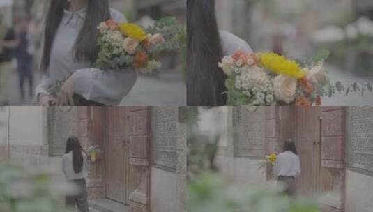 云南昆明怀抱鲜花的女孩走在街道上高清在线视频素材下载