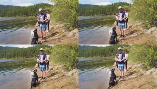 夫妇把棍子扔进湖里训练狗狗高清在线视频素材下载