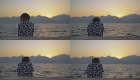 孤独的男孩坐在海边高清在线视频素材下载