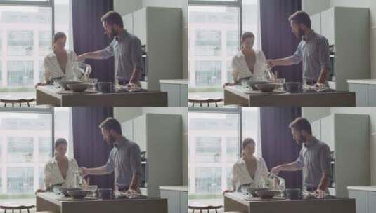 幸福的夫妇在现代厨房喝水高清在线视频素材下载