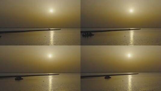 海边水面夕阳宁静浪漫人影渔船渔民高清在线视频素材下载