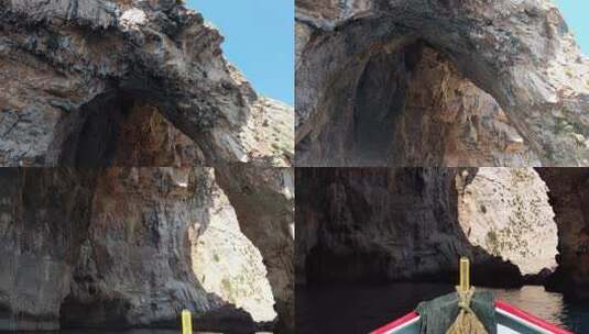 在阳光明媚的夏日，传统的luzzu渔船在马耳他蓝色洞穴的岩石洞穴下航行高清在线视频素材下载