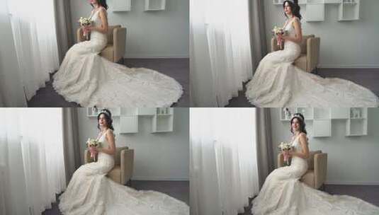 迷人的年轻新娘穿着婚纱坐在扶手椅上，手里拿着一大束花，做着白日梦高清在线视频素材下载